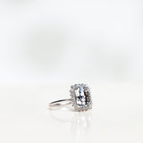 Solitaire Ring with White Topaz and Diamond Halo in White Gold